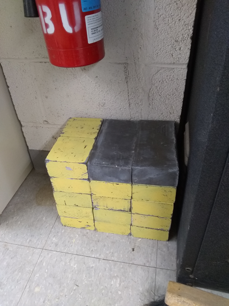 Stack of lead bricks, mostly yellow