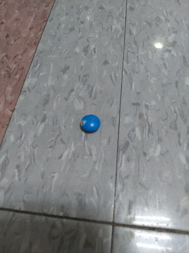 Blue M&M on the floor.