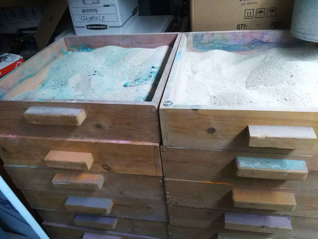 Bins of colorful sand.