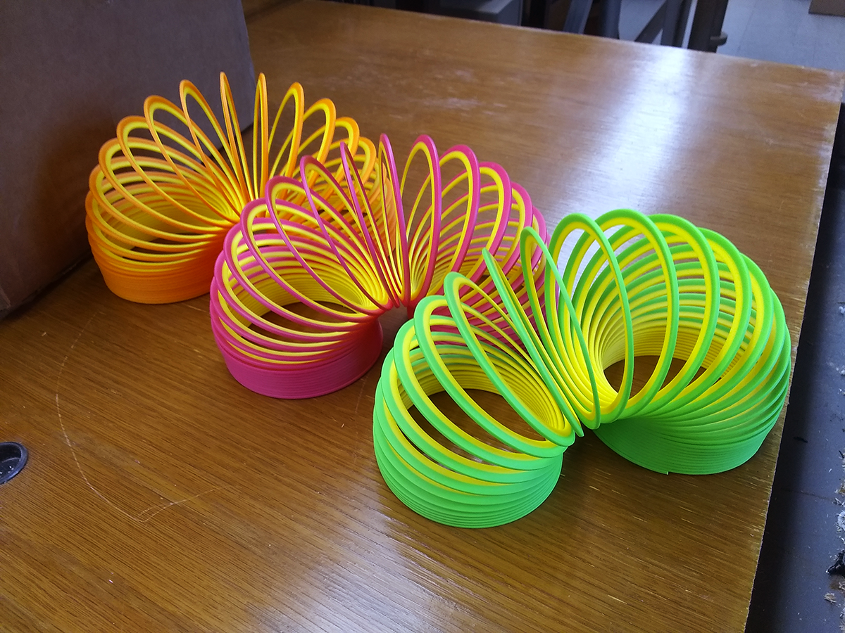 Three colorful Slinky coils