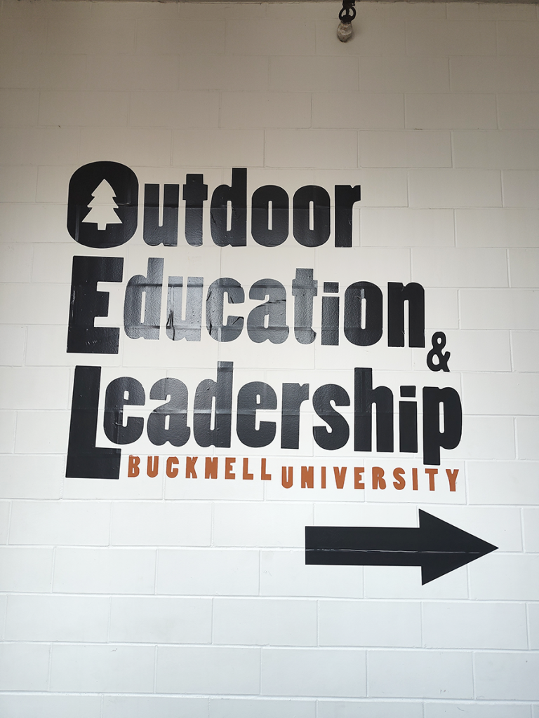 Painted wall sign reading Outdoor Education & Leadership, Bucknell University