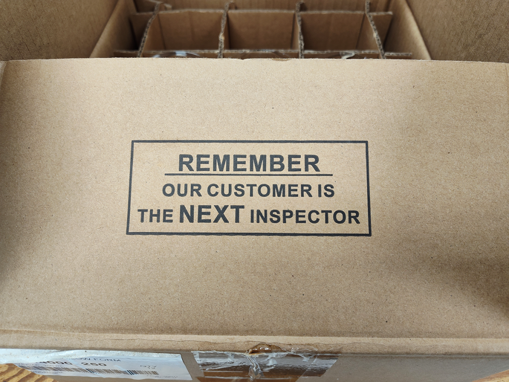 Box marked with "Remember: our customer is the NEXT inspector"