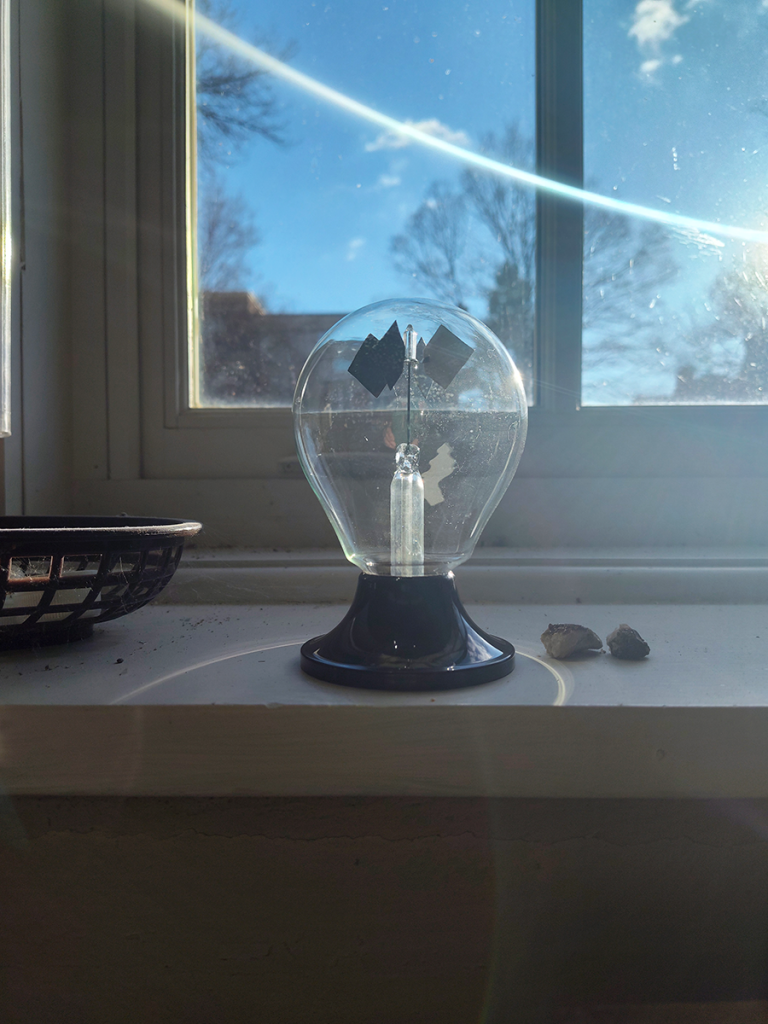 Spinning Crookes radiometer on a sunny windowsill.