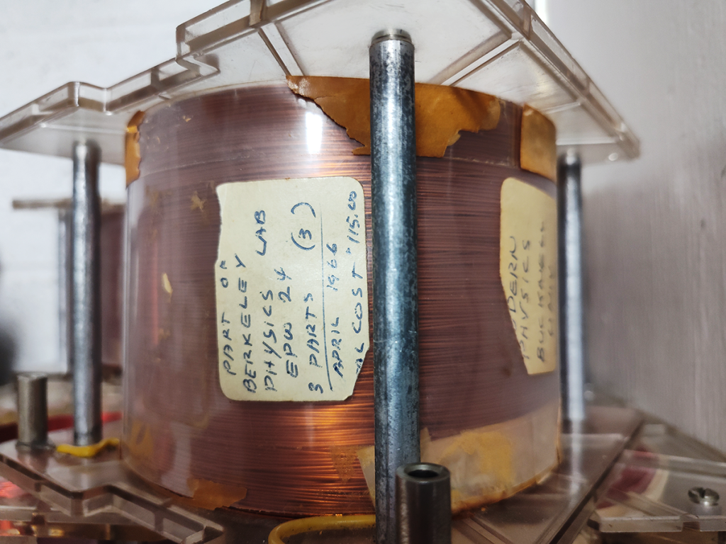 Coil of enameled magnet wire in a plastic and steel frame.