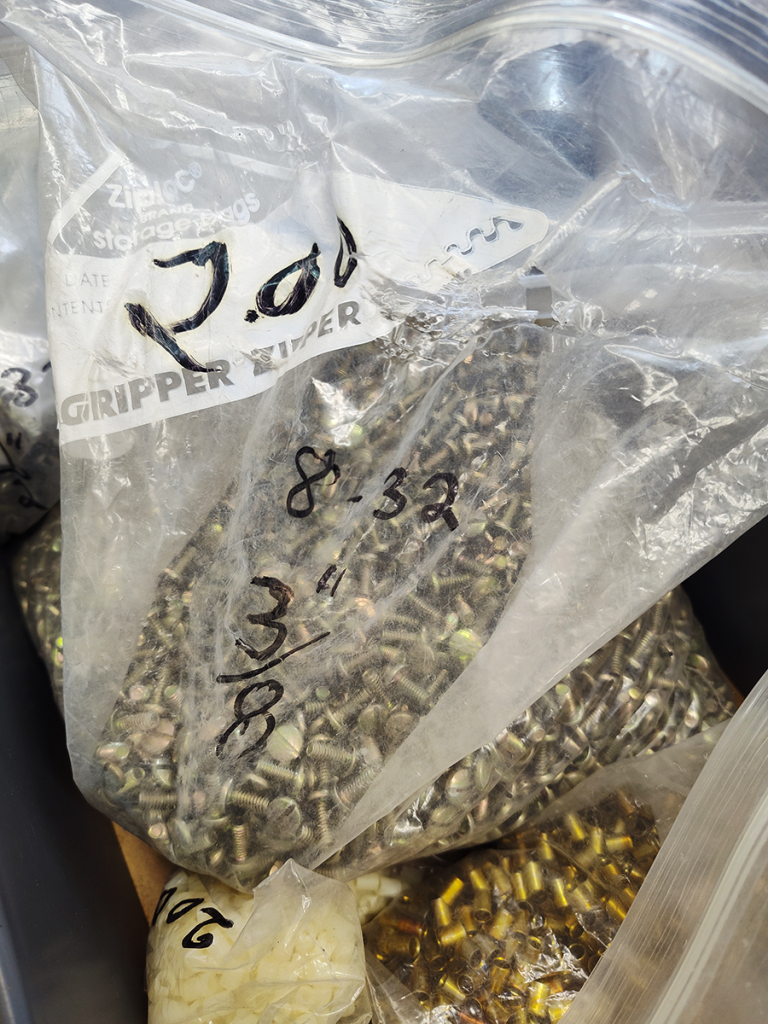 One gallon zip-top bag filled with machine screws.